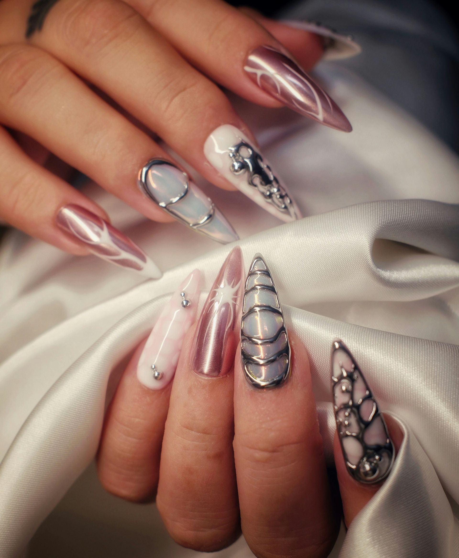 Woman's hands with metallic and jeweled stiletto nails