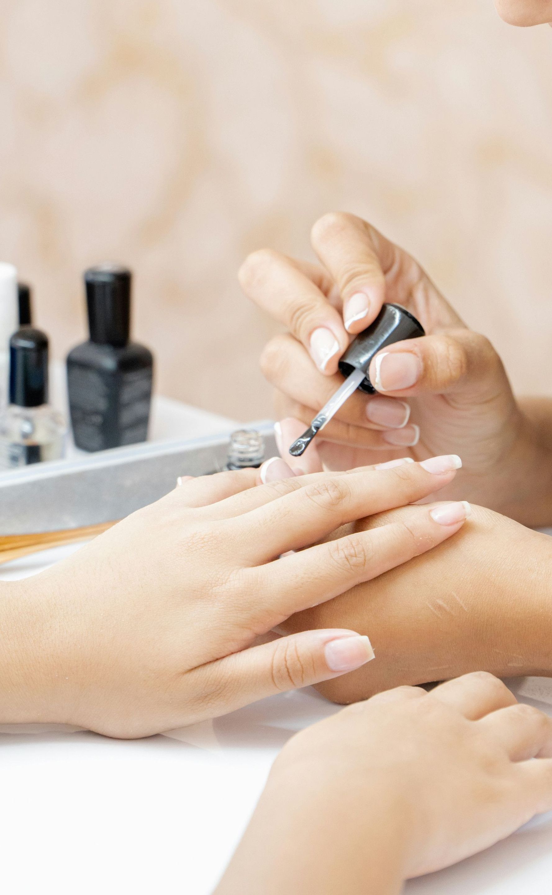 a woman is doing a manicure on a child's hand